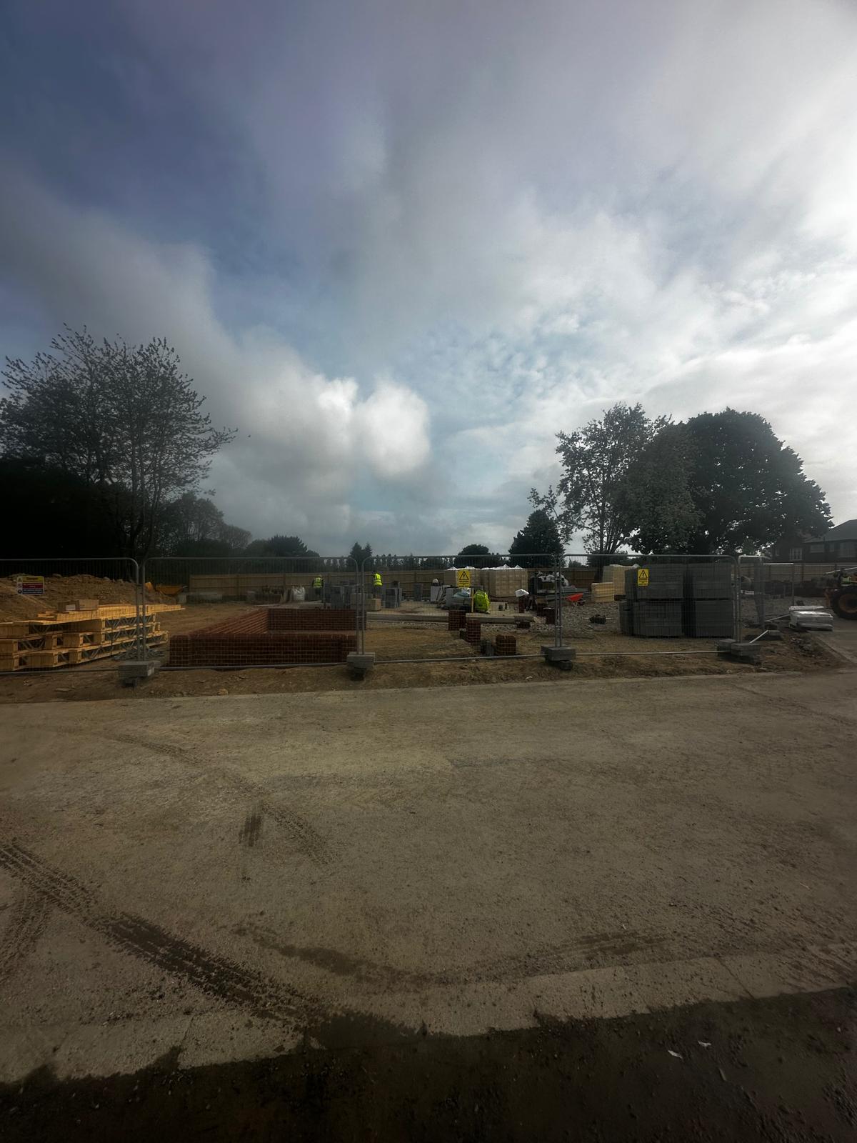 Elite Contractors construction site with excavator and brickwork